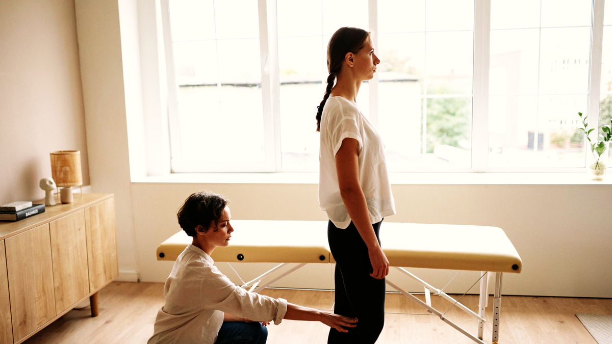 Physiotherapist and patient in a bright treatment room