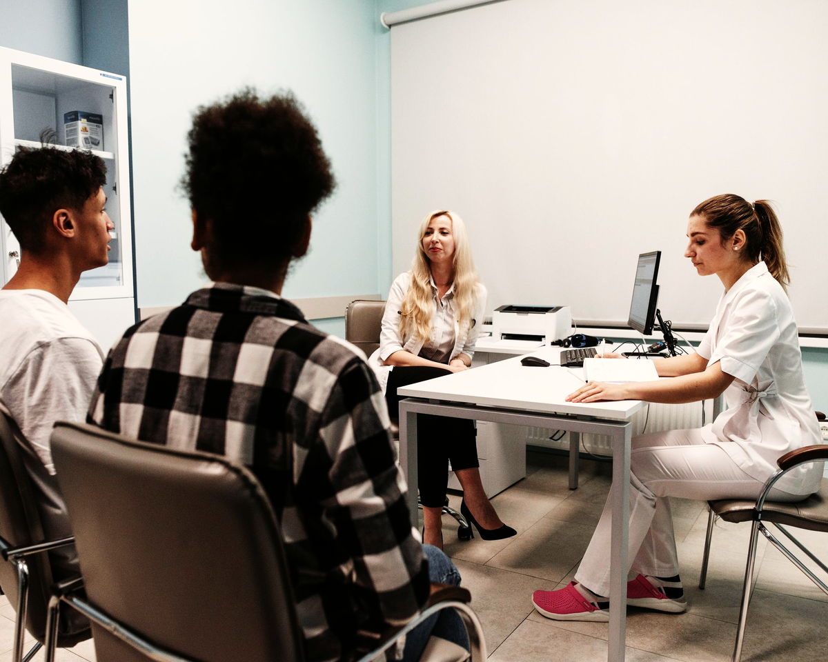 A family in conversation with a doctor at a clinic
